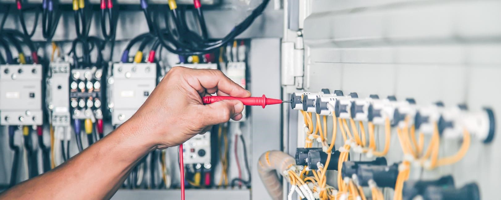 Electrician doing maintenance on an electrical panel